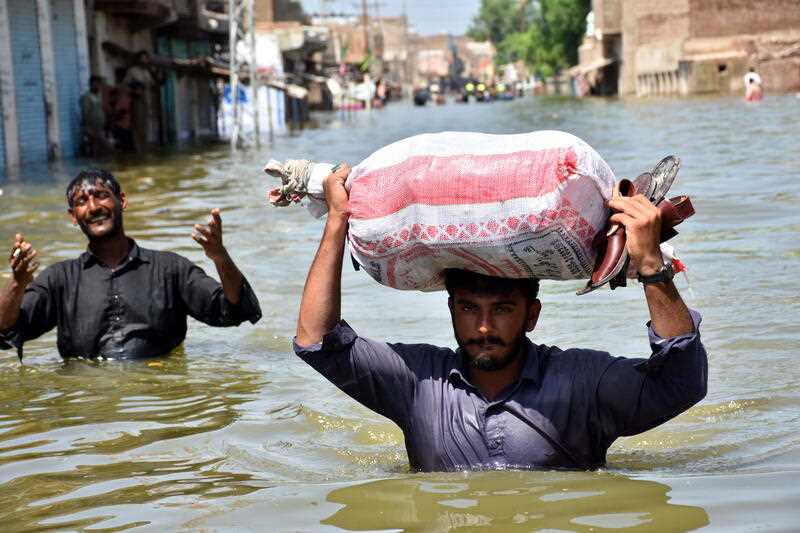 People affected by floods move to higher grounds in Khairpur Nathan Shah, Dadu district, Sindh province, Pakistan, 03 September 2022.