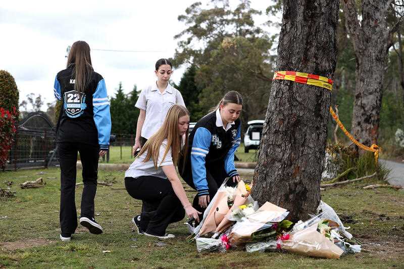 Students from Picton High School leave flowers at the crash site at Buxton, southwest of Sydney, Wednesday, September 7, 2022.