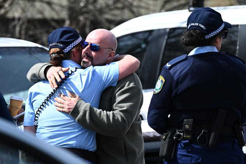 Exaven Desisto, the father of vicitim Antonio, embraces Police officers outside Picton local court, NSW Thursday, September 8, 2022.