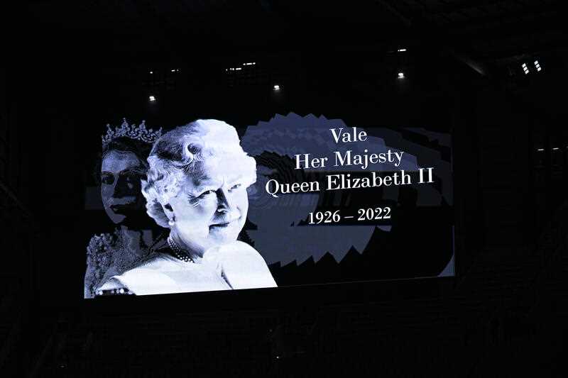 Signage is displayed on a big screen following the death of Britain's Queen Elizabeth II during the AFL Semi Final match between the Melbourne Demons and the Brisbane Lions at the Melbourne Cricket Ground in Melbourne, Friday, September 9, 2022