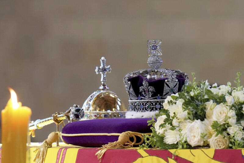 The Imperial State Crown and the Sovereign's orb and sceptre are seen on the coffin of Queen Elizabeth II, draped in the Royal Standard during it's lying in state on the catafalque in Westminster Hall, at the Palace of Westminster, in London