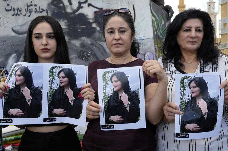3 Kurdish women activists hold portraits of Iranian Mahsa Amini, during a protest against her death in Iran, at Martyrs' Square in downtown Beirut, Wednesday, Sept. 21, 2022