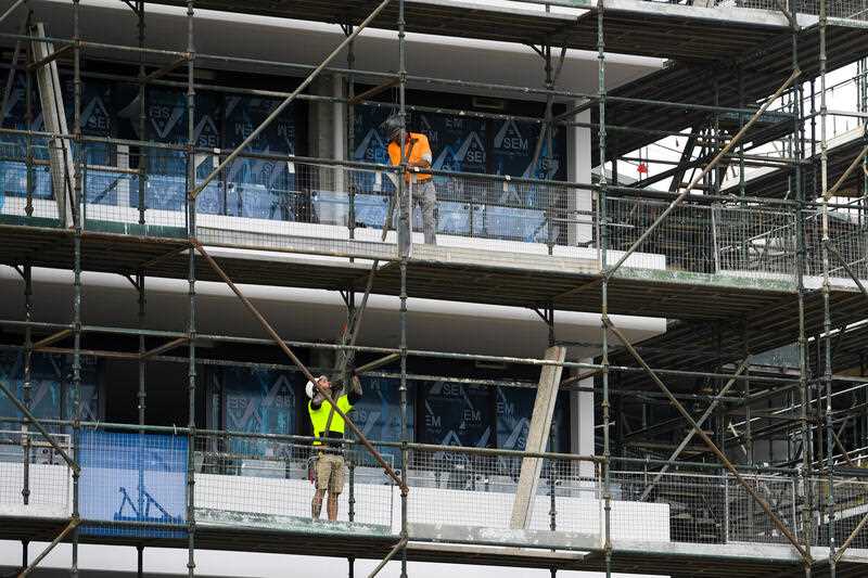 Workers are seen at a multi-storey construction site in Canberra