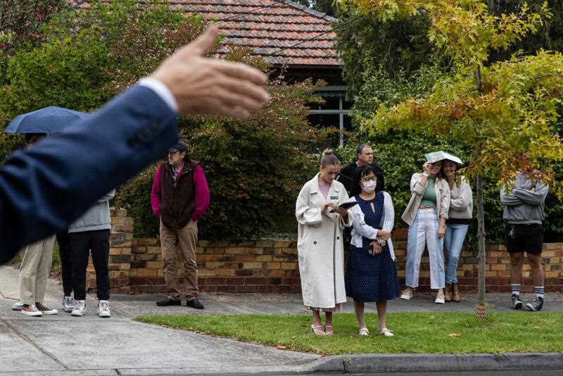 Bidders look on during a property auction at Glen Iris in Melbourne