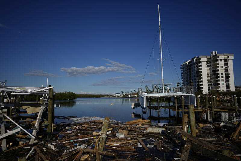 A catamaran rests atop a dock in Getaway Marina, which was destroyed during the passage of Hurricane Ian, most of its boats left scattered on the road or stuck in the mangroves in Florida