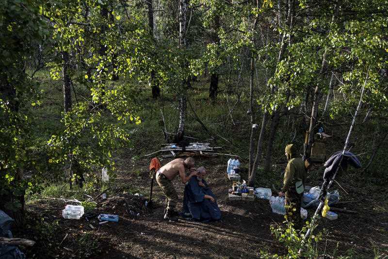 A Ukrainian serviceman gets a haircut in his unit position in the recently recaptured town of Lyman, Ukraine