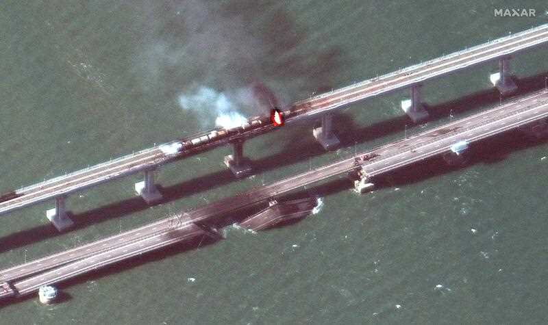 satellite image shows smoke and a collapsed part of the Kerch Strait bridge in Crimea