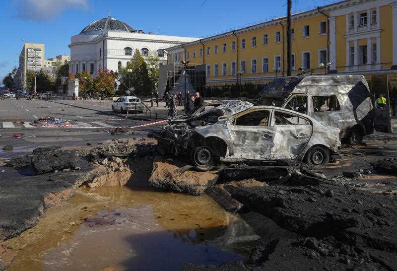 Police inspect the scene of Russian shelling in Kyiv, Ukraine, Monday, Oct. 10, 2022. Multiple explosions rocked Kyiv early Monday following months of relative calm in the Ukrainian capital