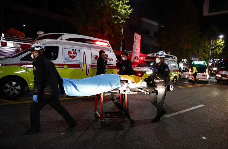 Rescuers move a victim on a stretcher in Seoul's Itaewon district after a stampede during Halloween parties in Seoul, South Korea, 30 October 2022