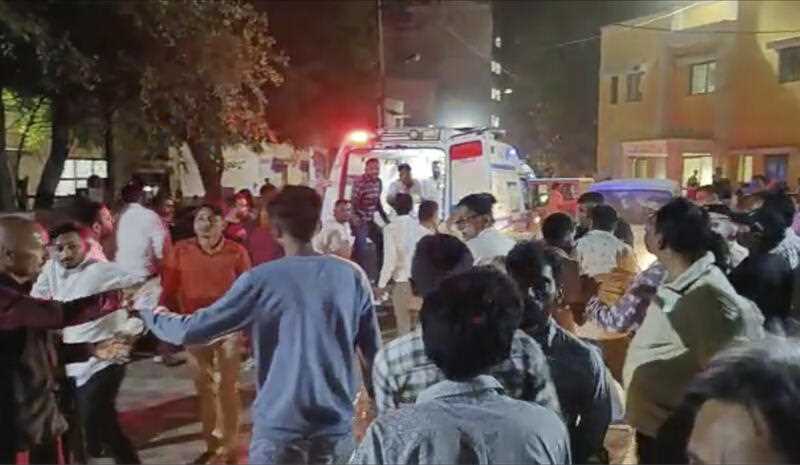 commotion outside a hospital where victims of a cable bridge collapse are being rushed in for treatment in Morbi district, western Gujarat state, India, Sunday, Oct.30, 2022.