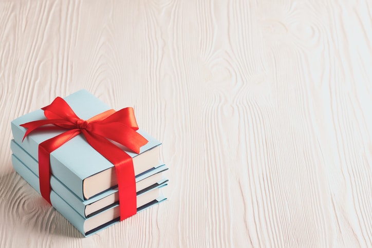 Books tied with ribbon on a wooden background