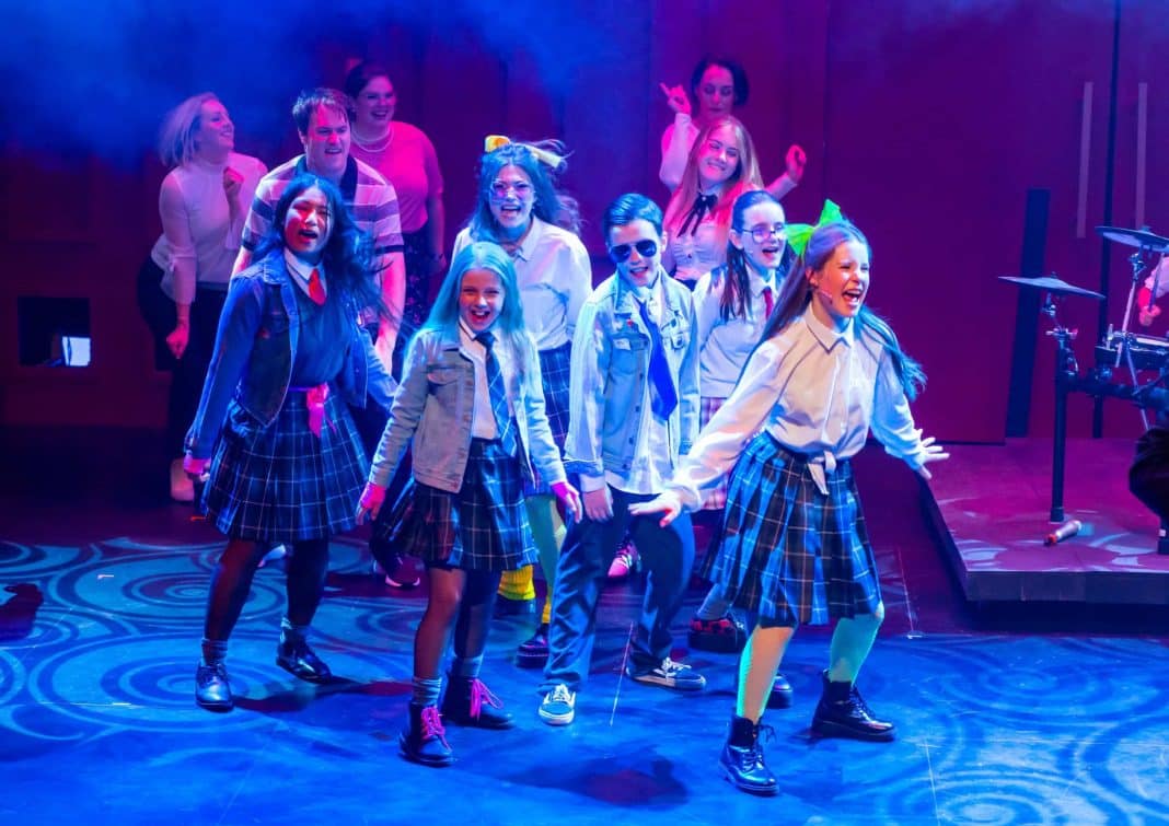 actors in school uniform performing a scene from School of Rock the musical