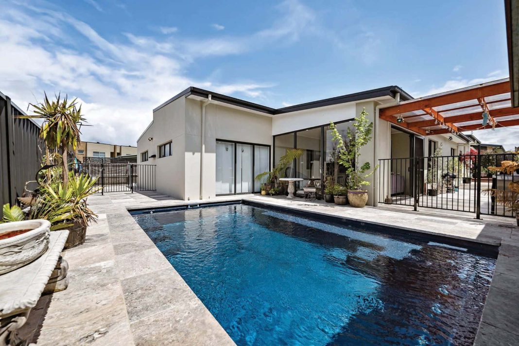 contemporary Canberra home with sparkling inground pool in backyard
