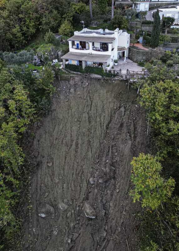 A house is left standing on the edge of a landslide in Casamicciola, on the southern Italian island of Ischia, in this picture taken Sunday, Nov. 27, 2022.