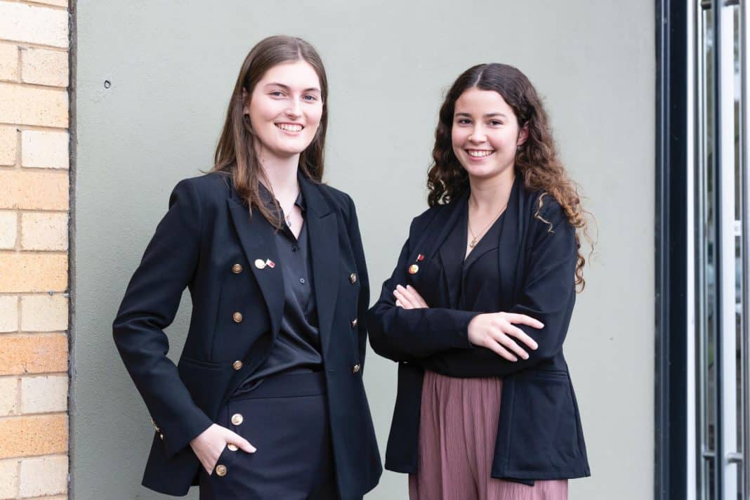 Two smiling young professional women