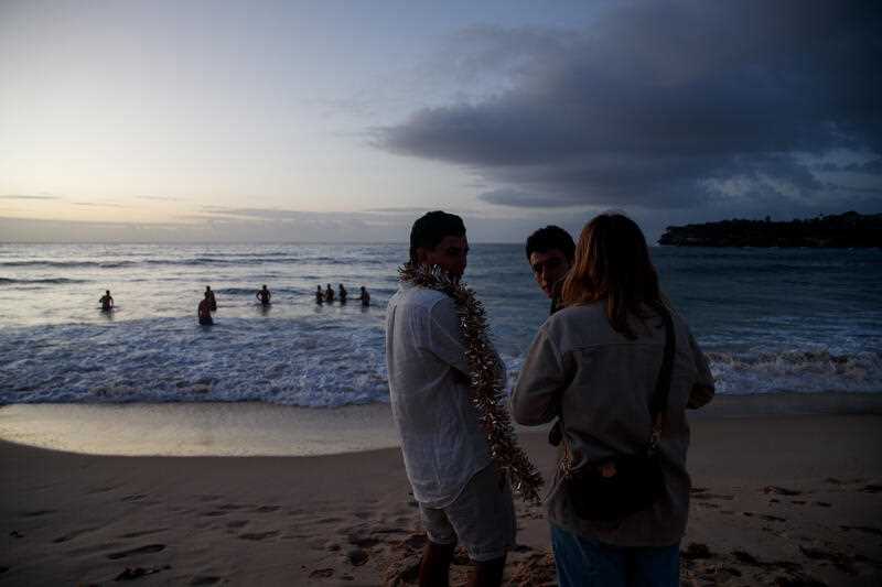 A small group of revellers watch the sunrise on New Year’s Day at Bondi Beach in Sydney, Sunday, January 1, 2023.
