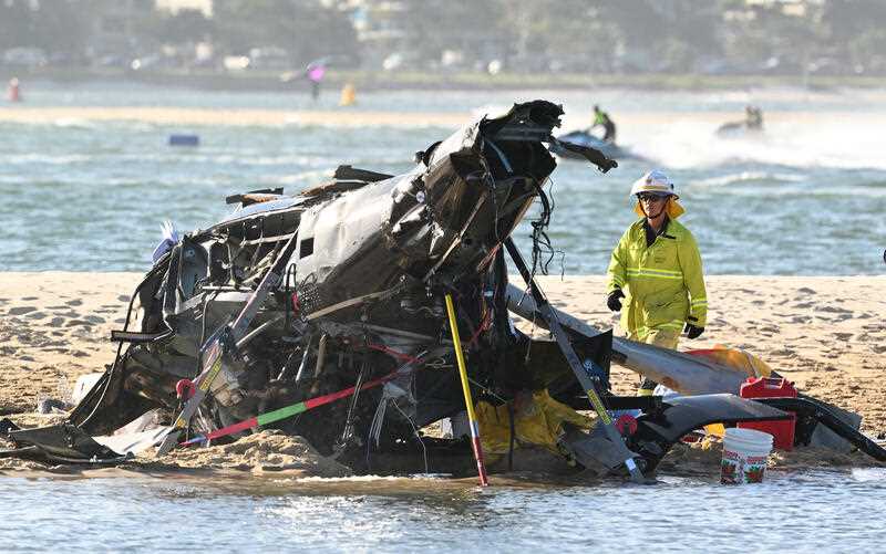 The wreckage of a helicopter is seen following a collision near Seaworld, on the Gold Coast, Monday, January 2, 2023