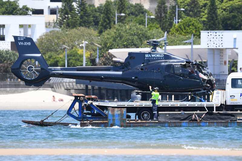 A damaged Helicopter is towed away on the Broadwater, on the Gold Coast, Tuesday, January 3, 2023