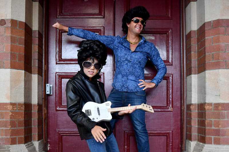 Will Mather (8) and father Chris Mather pose for a photograph dressed as Elvis Presley in the style of his movie ‘Blue Hawaii’ as they wait for the departure of the Elvis Express train at Central Station in Sydney, Thursday, January 5, 2023