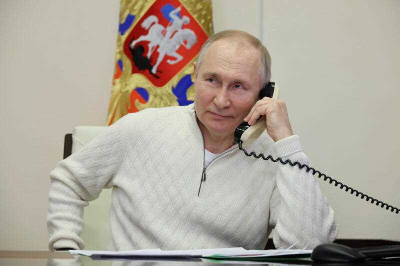 Russian President Vladimir Putin speaks on the phone