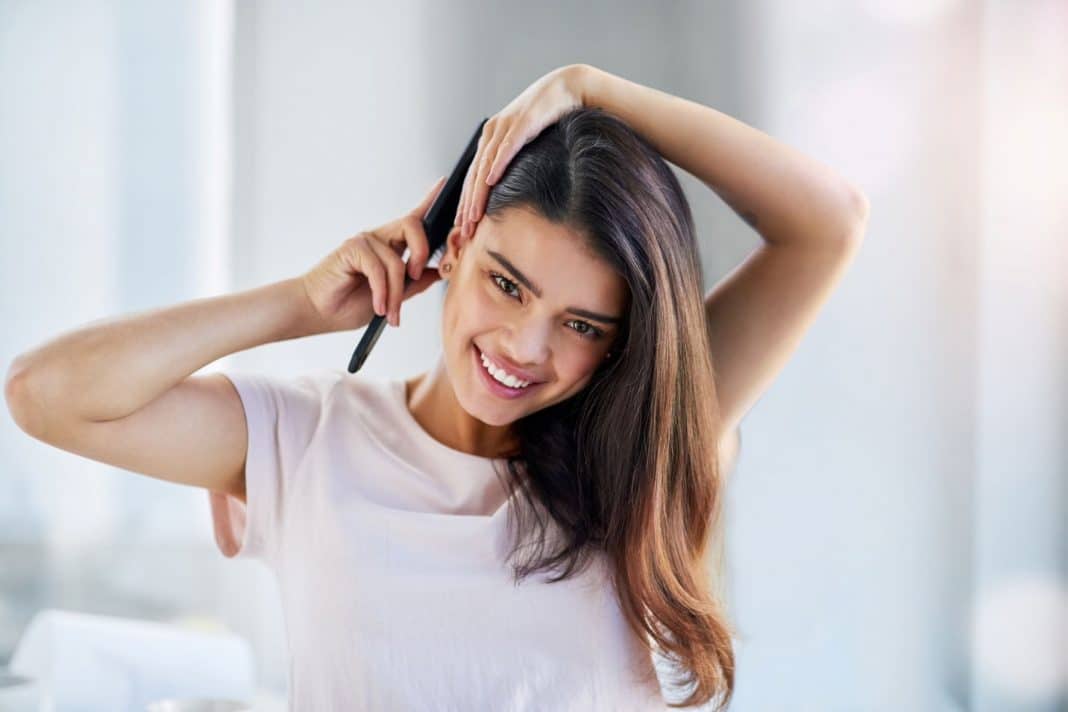 beautiful woman brushing her long dark hair