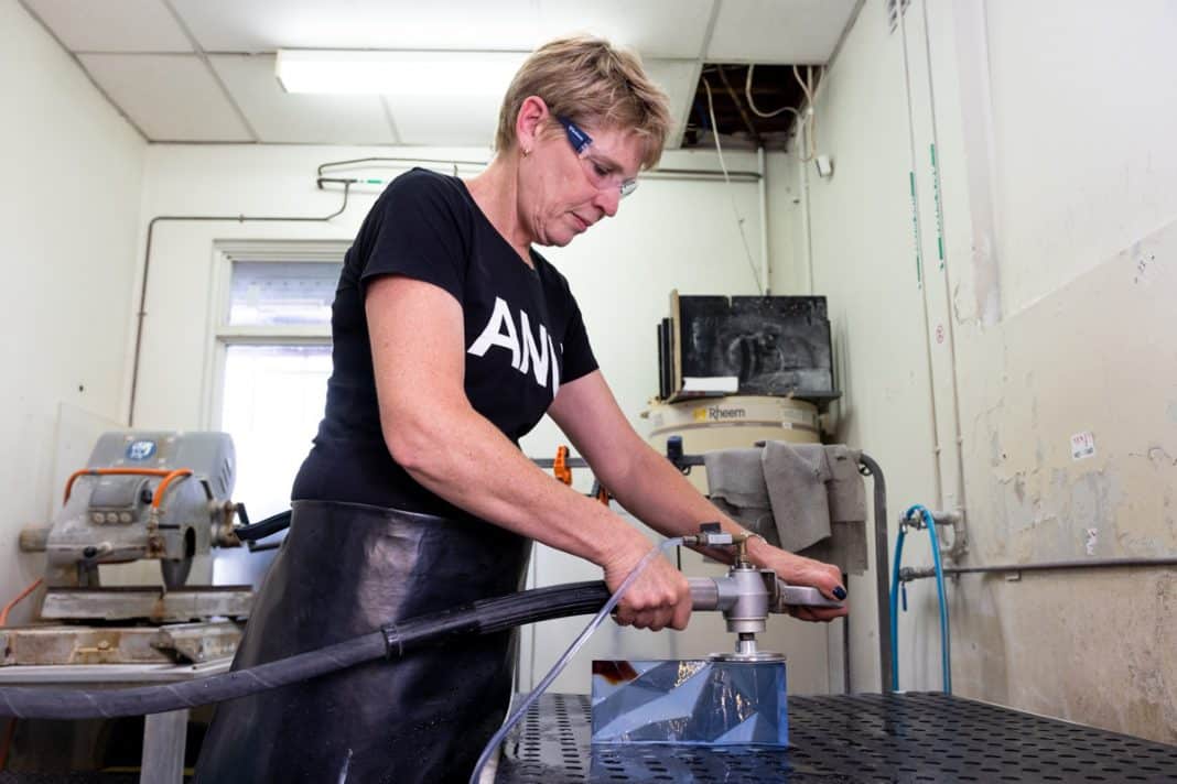 Cathy Newton polishing the Australian of the Year awards at the ANU School of Art and Design's Glass Workshop. Photo: Kerrie Brewer