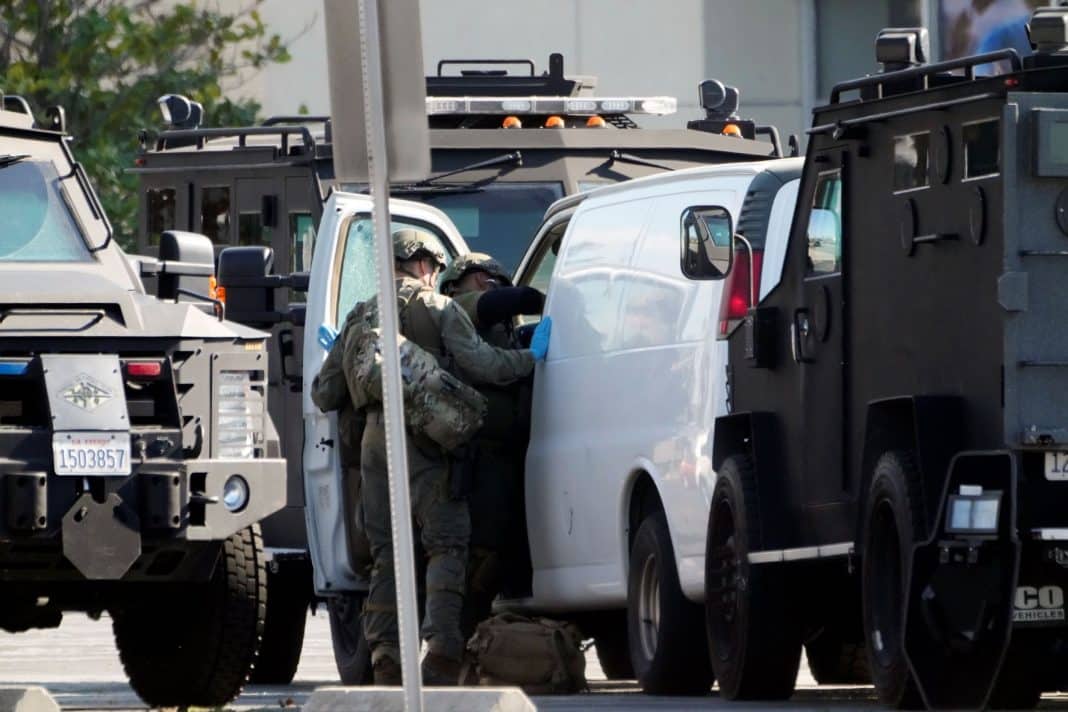 Members of a SWAT team enter a van and look through its contents in Torrance Calif., Sunday, Jan. 22, 2023