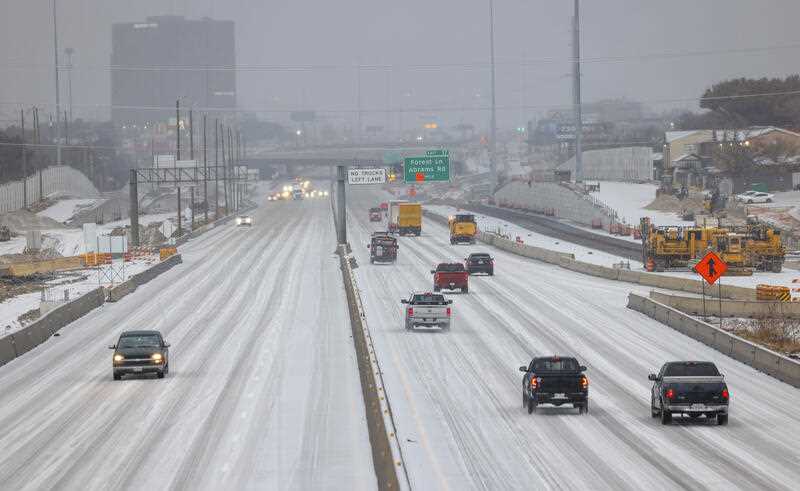 Cars drive along icy roads on U.S. 75 near Skillman Street in Dallas on Tuesday, Jan. 31, 2023.