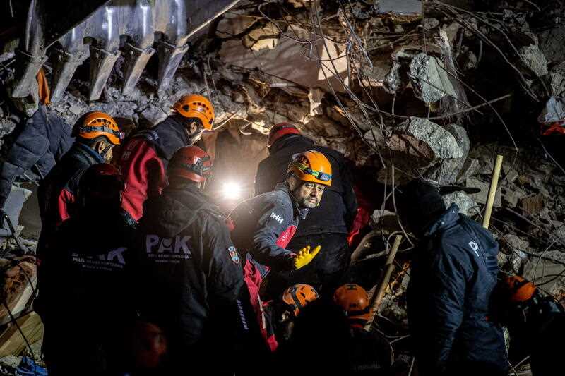 Rescuers work at the site of collapsed buildings after a powerful earthquake, in Hatay, Turkey, 13 February 2023