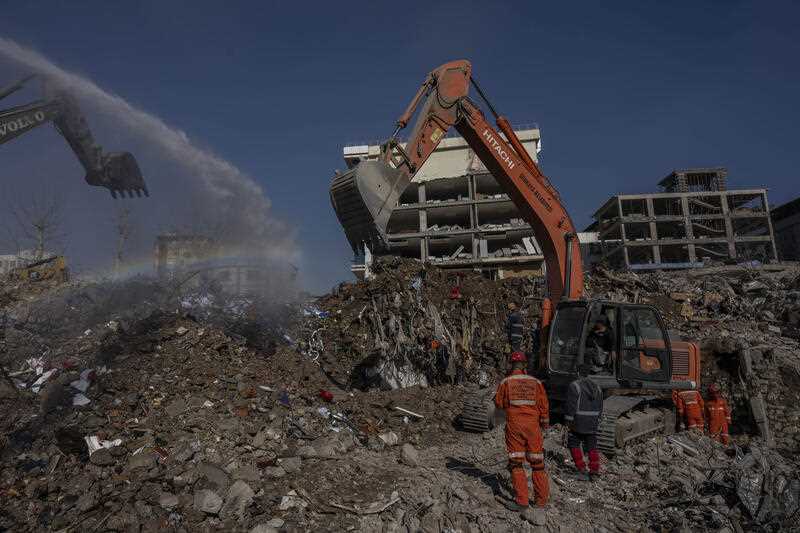 Excavators work at the site of buildings that collapsed during the earthquake in Kahramanmaras, Turkey