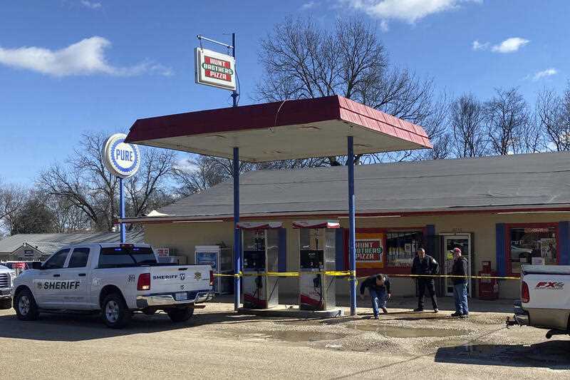 Law enforcement personnel work at the scene of a fatal shooting of 6 people in the small rural town of Arkabutla in Mississippi