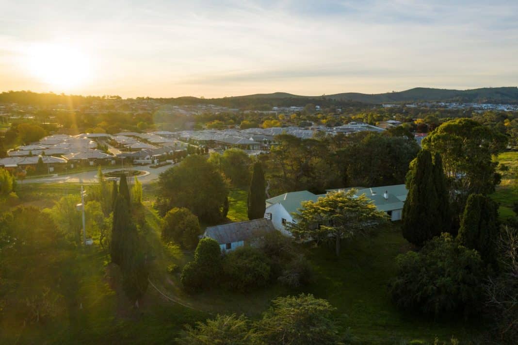 drone shot of historic Gold Creek Homestead and surrounding leafy suburb