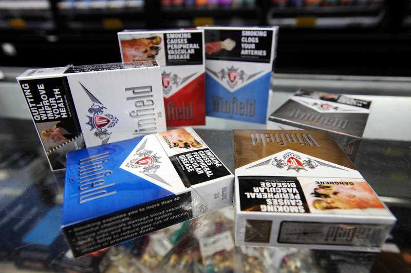 Generic image of branded cigarette packets at a tobacconist shop