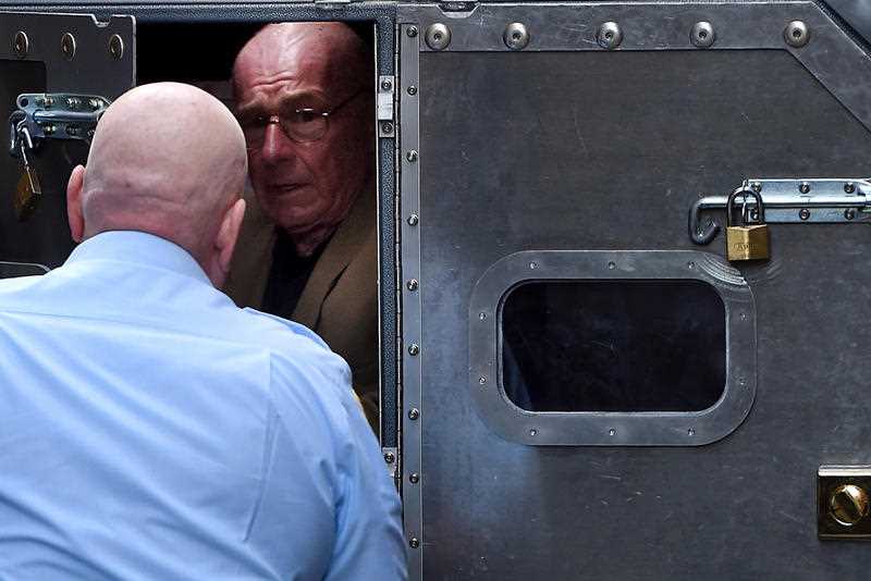 Former detective Roger Rogerson is escorted to a prison van at the Supreme Court in Sydney, Wednesday, June 15, 2016.