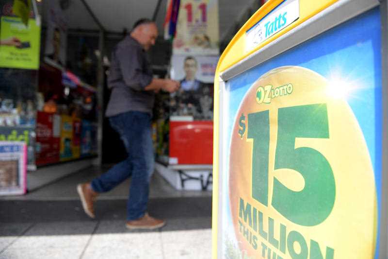 OzLotto signs are seen outside a newsagency