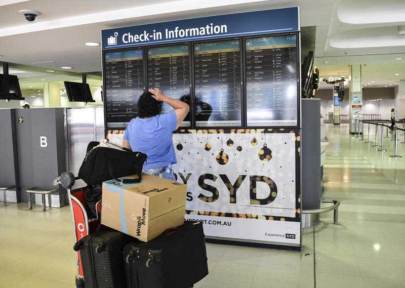 Travellers are seen at Overseas Arrivals and Departures (OAD) at Sydney's International Airport