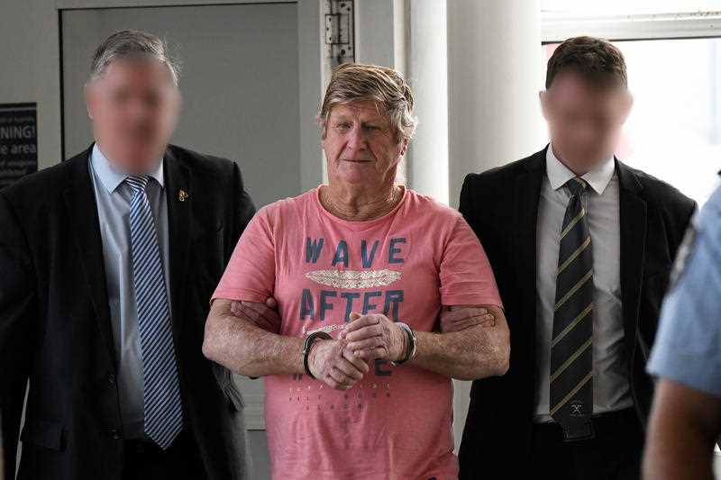 John Bowie is seen arriving via police escort at Sydney Domestic Airport in Sydney, Saturday, October 5, 2019