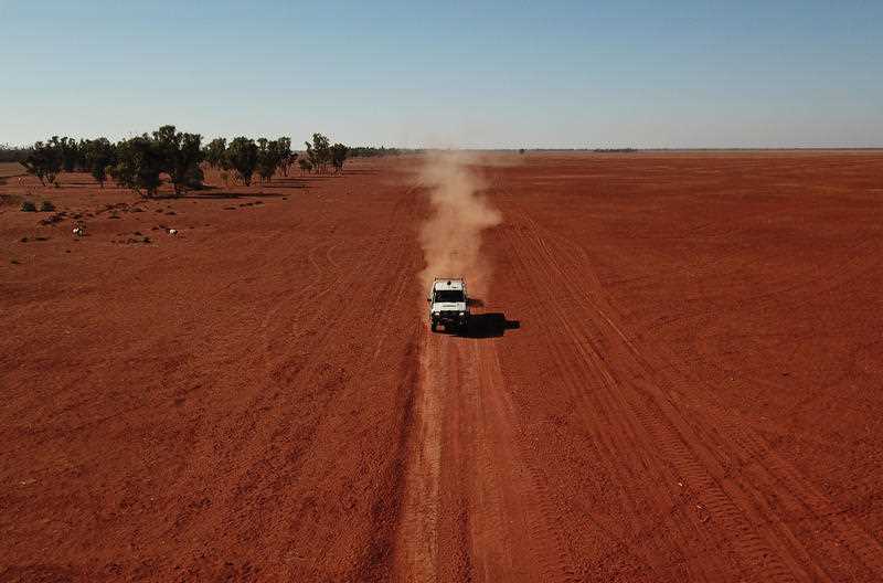 A grazier in a 4WD drives through a drought affected property during a stock feed run near Bollon in southwest Queensland, Saturday, October 12, 2019