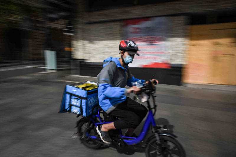 A food delivery driver is seen riding a pushbike