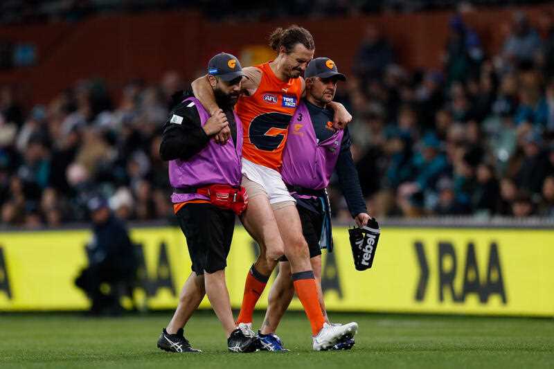 Phil Davis of the Giants leaves the field injured during the AFL Round 17 match between Port Adelaide Power and the GWS Giants at Adelaide Oval in Adelaide, Saturday, July 9, 2022