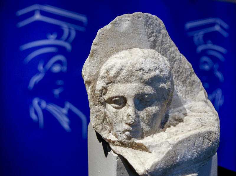 The marble head of a young man, a tiny fragment from the 2,500-year-old sculptured decoration of the Parthenon Temple on the ancient Acropolis, is displayed during a presentation to the press at the Acropolis Museum in Athens in 2008