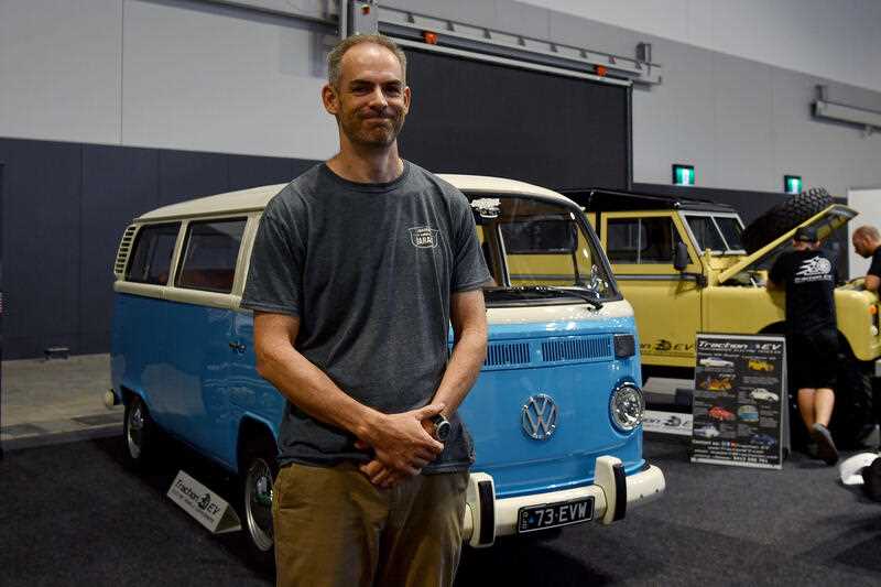 Tim Harrison poses with his 1973 Volkswagen Combi, which has a Tesla swap conversion installed, at the Fully Charged Live convention at the ICC Sydney Theatre in Sydney, Friday, March 10, 2023