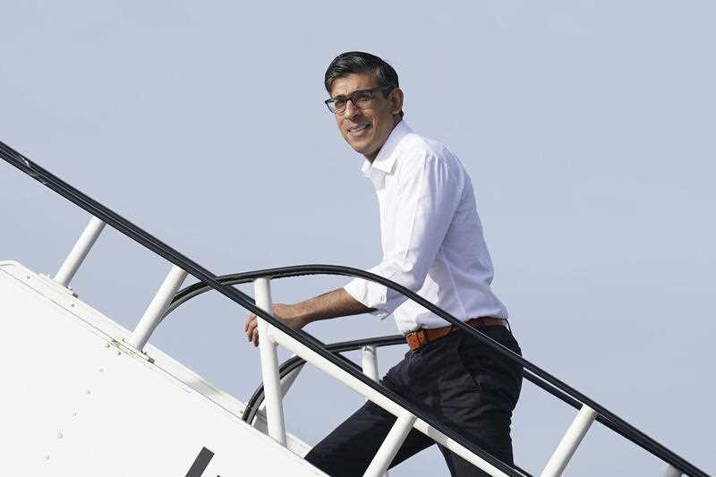 Britain's Prime Minister Rishi Sunak boards a plane at Stansted Airport, England