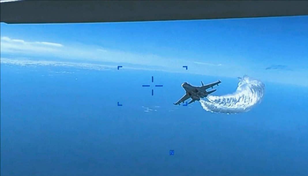 This photo taken from video released on Thursday, March 16, 2023, shows a Russian Su-27 approaching the back of the MQ-9 drone and beginning to release fuel as it passes, over the Black Sea, the Pentagon said