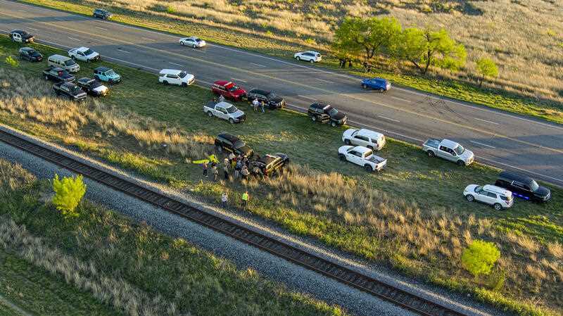 Officials investigate the scene where migrants were found trapped in a train car, Friday, March 24, 2023 in Ulvalde, Texas