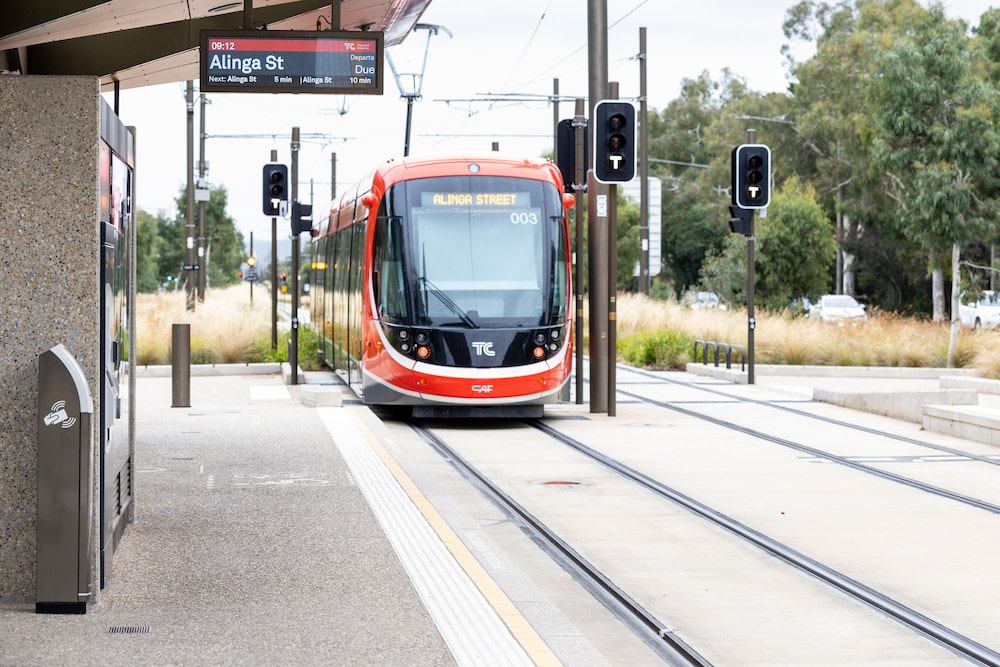 red light rail vehicle approaching station in Canberra