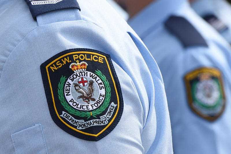 New South Wales Police badges seen on upper sleeve of uniforms being worn by officers