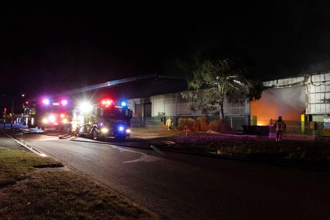Firefighters working at night at the ACT government's Materials Recovery Facility in the suburb of Hume in Canberra