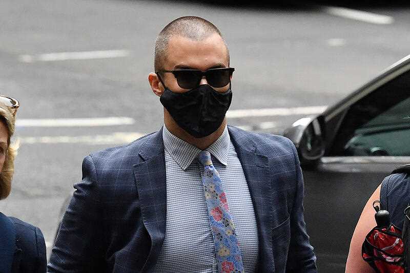man wearing black face mask and sunglasses arriving at court in Sydney