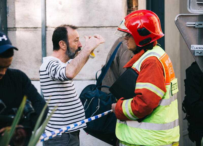A resident speaks to emergency services at the site of an explosion April 09, leading to the collapse of a building in Marseille, France, 10 April 2023